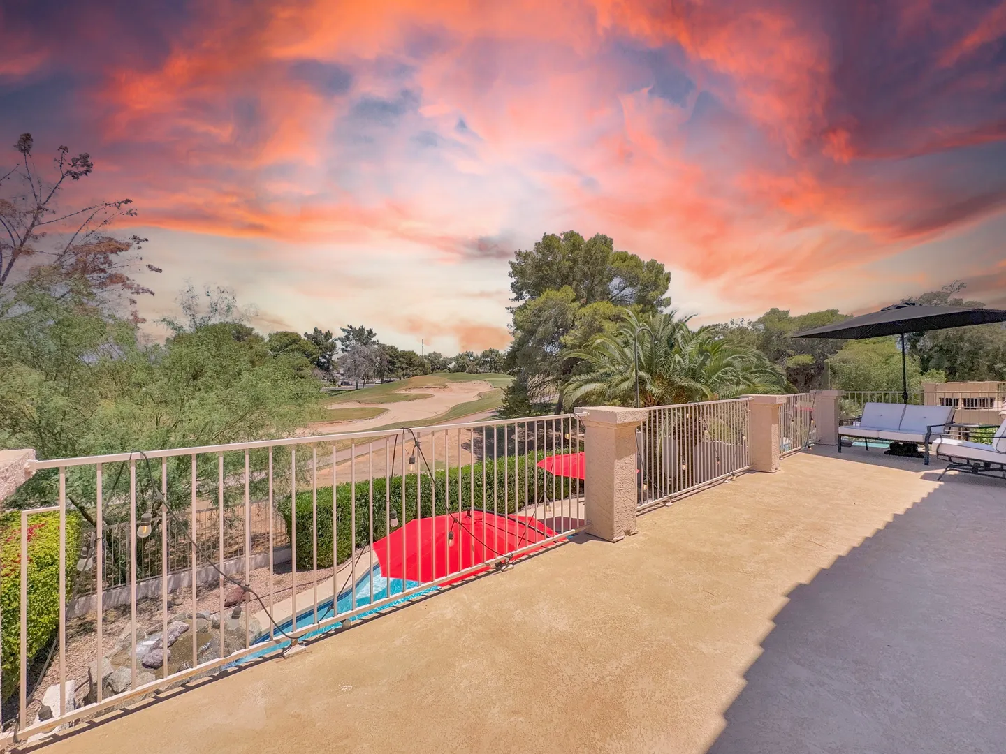 Upstairs balcony overlooking the golf course under a pink and orange sky